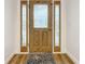 Elegant oak wood door with glass inserts and sidelights at 3005 Enisglen Dr, Palm Harbor, FL 34683