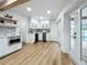 Modern kitchen with white cabinets, wine cooler, and light wood floors at 3005 Enisglen Dr, Palm Harbor, FL 34683