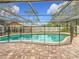 Relaxing kidney-shaped pool with safety fence at 3005 Enisglen Dr, Palm Harbor, FL 34683