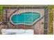 Aerial view of screened-in kidney-shaped pool at 3005 Enisglen Dr, Palm Harbor, FL 34683