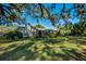 Spacious backyard with large oak tree and home view at 3147 Hyde Park Dr, Clearwater, FL 33761