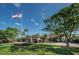 Country club clubhouse with flag and landscaping at 3147 Hyde Park Dr, Clearwater, FL 33761