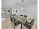 Elegant dining room with glass table and black chairs, offering views to the pool at 3147 Hyde Park Dr, Clearwater, FL 33761