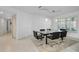 Modern dining room with glass table, black chairs, and neutral color scheme at 3147 Hyde Park Dr, Clearwater, FL 33761