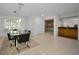 Bright dining room features glass table, black chairs, and views to the home's interior at 3147 Hyde Park Dr, Clearwater, FL 33761