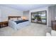 Large main bedroom with sliding doors opening to a view of the pool at 3147 Hyde Park Dr, Clearwater, FL 33761