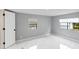 Well-lit bedroom featuring grey walls and marble-look floors at 36905 Kay Ave, Zephyrhills, FL 33542