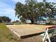 Two bocce ball courts under a large tree at 36905 Kay Ave, Zephyrhills, FL 33542