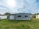 Gray mobile home exterior with storage building at 36905 Kay Ave, Zephyrhills, FL 33542