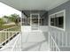 Screened porch with white railing and gray flooring at 36905 Kay Ave, Zephyrhills, FL 33542