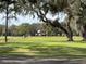 Green golf course with trees and flags at 36905 Kay Ave, Zephyrhills, FL 33542