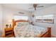 Charming bedroom with a floral comforter and wood frame bed at 37025 Karen Ave, Zephyrhills, FL 33542