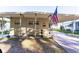 Tan mobile home exterior with covered carport and American Flag at 37025 Karen Ave, Zephyrhills, FL 33542