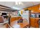 Kitchen with wood cabinets, breakfast bar, and view of living room at 37025 Karen Ave, Zephyrhills, FL 33542