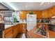 Galley kitchen with wood cabinets and a breakfast nook at 37025 Karen Ave, Zephyrhills, FL 33542