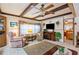 Living room with wood-beamed ceiling, recliner, and fireplace at 37025 Karen Ave, Zephyrhills, FL 33542