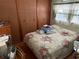 Primary bedroom with floral bedding and built-in closet at 37402 Hammond Dr, Zephyrhills, FL 33541