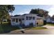 White single-wide mobile home with carport and small patio at 37402 Hammond Dr, Zephyrhills, FL 33541