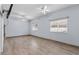 Spacious bedroom with wood-look tile flooring and ceiling fan at 4337 Waterford Landing Dr, Lutz, FL 33558