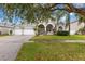 Two story house with a three-car garage and lush landscaping at 4337 Waterford Landing Dr, Lutz, FL 33558