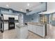 Modern kitchen with granite countertops, stainless steel appliances, and an island at 4337 Waterford Landing Dr, Lutz, FL 33558