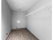 Laundry room with wire shelving and wood-look tile floor at 4337 Waterford Landing Dr, Lutz, FL 33558