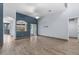 Living area with wood-look tile floors, blue walls, and sliding glass doors at 4337 Waterford Landing Dr, Lutz, FL 33558