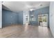 Living room with wood-like tile floors, blue accent walls, and access to a patio at 4337 Waterford Landing Dr, Lutz, FL 33558