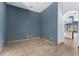 Empty office room with wood-look tile floor and blue walls at 4337 Waterford Landing Dr, Lutz, FL 33558