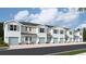 Five-unit townhome building with light blue exterior and attached garages at 4644 Pleasant Ave, Palm Harbor, FL 34683