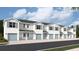 Row of modern townhomes with white exteriors, blue doors and shutters, and attached garages at 4652 Pleasant Ave, Palm Harbor, FL 34683