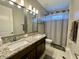 Double vanity bathroom with granite countertops and shower/tub at 5110 San Martino Dr, Wesley Chapel, FL 33543