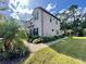 Exterior view of a two-story house with landscaping and walkway at 5110 San Martino Dr, Wesley Chapel, FL 33543