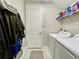 Laundry room with washer, dryer, and shelving at 5110 San Martino Dr, Wesley Chapel, FL 33543