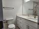 Modern bathroom with white cabinets, quartz countertop, and a large mirror at 5211 Peach Ave, Seffner, FL 33584