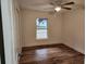 Light-filled bedroom featuring wood-look floors and a window at 5211 Peach Ave, Seffner, FL 33584