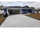 Newly built home with blue exterior and a two-car garage at 5211 Peach Ave, Seffner, FL 33584