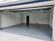 Spacious garage featuring an epoxy floor and access door at 5211 Peach Ave, Seffner, FL 33584