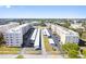 Aerial view of a condominium complex featuring two buildings, parking, and landscaping at 5705 80Th N St # 210, St Petersburg, FL 33709