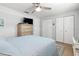 Comfortable bedroom with light blue bedding, wood floors, and ample closet space at 5705 80Th N St # 210, St Petersburg, FL 33709