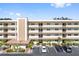 Exterior view of a condo building with ample parking and landscaping at 5705 80Th N St # 210, St Petersburg, FL 33709