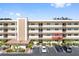 Condo building showcasing a section with balconies and parking spaces at 5705 80Th N St # 210, St Petersburg, FL 33709