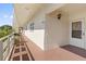 Condo hallway with light walls, a metal railing, and access to unit 210 at 5705 80Th N St # 210, St Petersburg, FL 33709