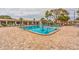 Community swimming pool with plenty of lounge chairs at 5705 80Th N St # 210, St Petersburg, FL 33709