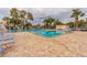 Community pool with lounge chairs at 5705 80Th N St # 210, St Petersburg, FL 33709