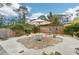 Stone patio with colorful chairs and umbrella in backyard at 5780 Elton Rd, Venice, FL 34293