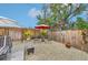 Relaxing backyard patio with seating area and wooden fence at 5780 Elton Rd, Venice, FL 34293