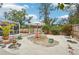 Landscaped backyard with stone patio and seating area at 5780 Elton Rd, Venice, FL 34293