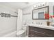 Updated bathroom with gray vanity and white tile at 5780 Elton Rd, Venice, FL 34293