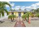 Bright yellow house with a red brick pathway and palm trees at 5780 Elton Rd, Venice, FL 34293